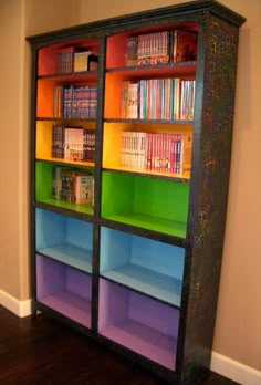 an image of a computer screen with books on the shelves in front of it that is lit up