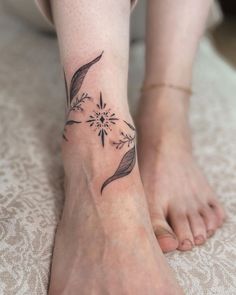 Embrace simplicity and beauty with this floral-inspired ankle tattoo. Featuring soft leaf designs and a geometric starburst centerpiece, this elegant tattoo is perfect for anyone seeking a minimalist yet eye-catching piece. Save this idea for your next ink! Ankle Calf Tattoo Wrap Around, Ankle Tattoo Large, Calf Wrap Tattoo, Dainty Botanical Tattoo, Ornamental Wrap Around Tattoo, Dragon Ankle Tattoo Wrap Around, Vine Thigh Tattoos Women, Around The Ankle Tattoo, Dainty Leg Tattoos Women