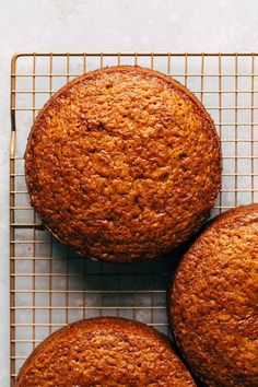 three muffins cooling on a wire rack