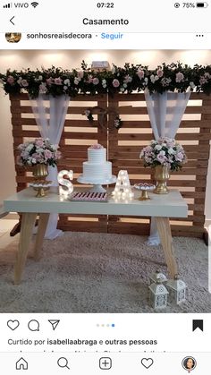 the table is decorated with pink flowers and white cake, along with other decorations on it