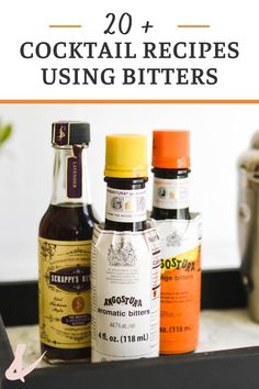 bottles of alcohol sitting on top of a counter with the words 20 cocktail recipes using bitters