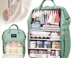 an open green backpack with baby items in it and the bottom compartment filled with diapers