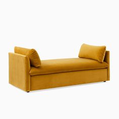 a yellow couch with two pillows on it's back and the seat upholstered