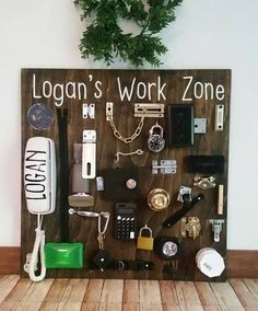 a wooden sign that says logan's work zone with various items on it