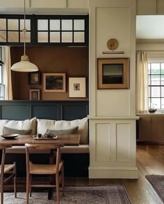 a living room filled with furniture and pictures on the wall