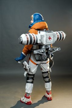 a man in an orange and white space suit carrying a child on his back,