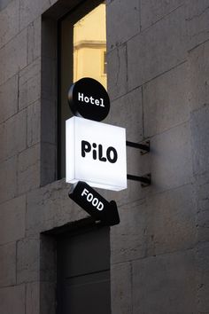 a hotel sign hanging off the side of a building