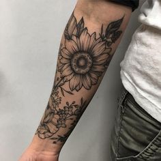 a person with a sunflower tattoo on their arm