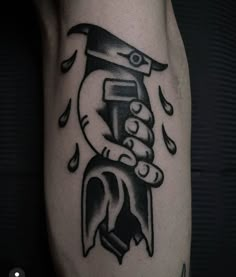 a black and white photo of a person's arm with a tattoo on it