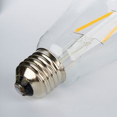 an old light bulb is turned on with yellow tape