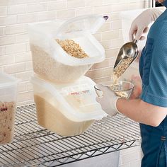 a woman in white gloves pouring oatmeal into a container on a shelf