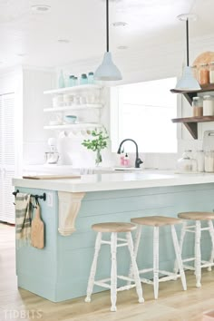 a kitchen island with three stools in front of it and the words saved all on