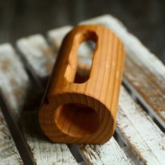 a wooden object sitting on top of a wooden table