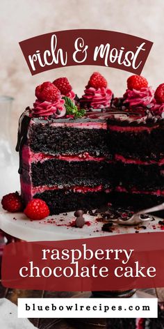 a chocolate cake with raspberry frosting and fresh raspberries on top