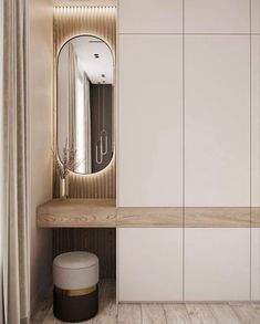 a white closet with a mirror and stool next to it in a room that has wood flooring