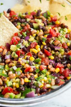 a bowl filled with beans, corn and tortilla chips