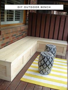 a white and black vase sitting on top of a wooden bench next to a yellow rug