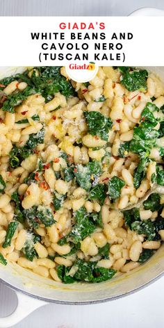 pasta with spinach and white beans in a skillet on top of a table