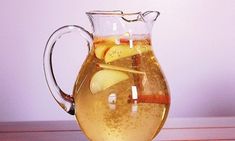 a pitcher filled with liquid sitting on top of a table