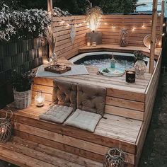 an outdoor hot tub with lights on the side and wooden steps leading up to it