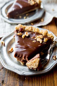 there is a piece of chocolate pie on the plate and another slice has been taken out