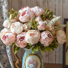 a vase filled with pink flowers on top of a table