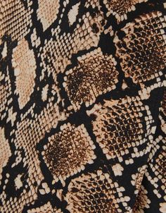 an animal print fabric is shown in brown and black