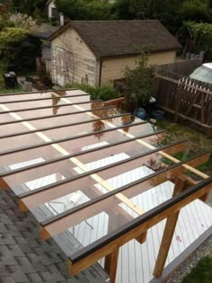 an overhead view of a wooden deck in the backyard with clear glass on top and bottom