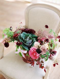 a bouquet of flowers sitting on top of a white chair