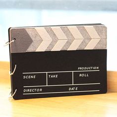 a movie clapper sitting on top of a wooden table