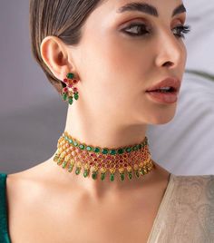 * Gold-Plated & Emerald Stone-Studded Jewellery Set * 22k Gold-Plated & emerald studded temple necklace secured with a drawstring closure * A pair of matching pair of earrings secured with a post-and-back closure *Size:- Necklace length: 18.6 cm Earrings length: 3.5 cm(each) *Material:- Material: Brass Plating: Gold-Plated NOTE All the raw material used in this product is of high quality and is handcrafted with love. Premium Quality and High craftsmanship 100% Satisfaction Guarantee: Long Lasting Plating, High-Quality Stones. Our jewellery is individually handcrafted by master artisans using meticulous crafting techniques. Resultantly, jewellery may have slight variations while retaining all aesthetics as reflecting in the product description. Such slight variation observed, if any, shall Ruby Choker Necklace Indian, Multicolor 22k Gold Bridal Necklace For Wedding, Green 22k Gold Bridal Necklace For Wedding, Green 22k Gold Temple Necklace For Wedding, Studded Jewellery, South Indian Necklace, Kemp Necklace, Indian Choker Necklace, Temple Jewelry