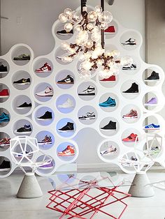 a room filled with lots of different types of shoes hanging on the wall next to each other