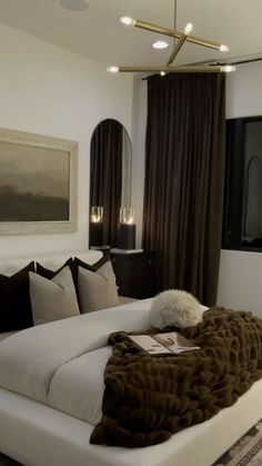 a large white bed sitting in a bedroom next to a tall painting on the wall