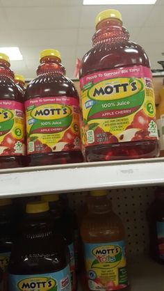 bottles of mott's apple juice are on the shelf