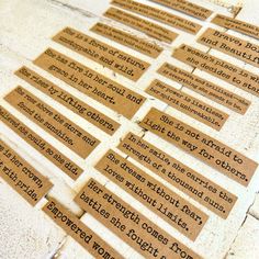 several pieces of brown paper with words on them sitting on the ground next to each other