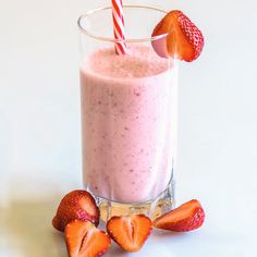 a smoothie with strawberries on the side