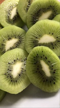 slices of kiwi are arranged on a white plate