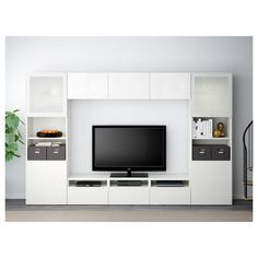 a white entertainment center with shelves and a flat screen tv mounted on it's side