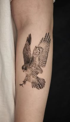 an eagle tattoo on the left arm