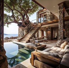 a living room with a pool and stairs leading up to it