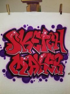 graffiti on a white canvas with purple and red spray paint