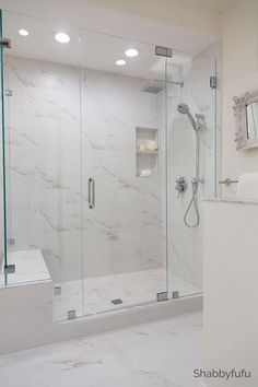 a bathroom with a walk in shower next to a sink