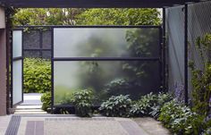 an outdoor area with plants and trees in the background