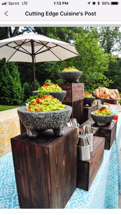 a table topped with bowls of food and an umbrella