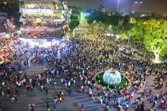 an aerial view of a crowded city square at night