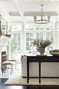 a dining room table with chairs and a vase on it