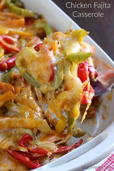 chicken fajita casserole in a white dish with a spoon