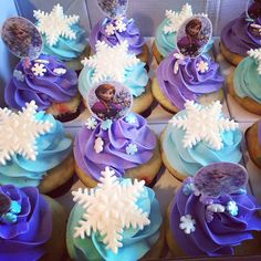 frozen princess cupcakes with blue frosting and snowflakes on them in a box