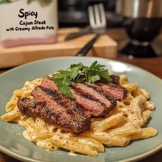 a plate with some meat and pasta on it