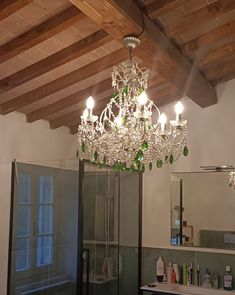 a chandelier hanging from the ceiling in a bathroom